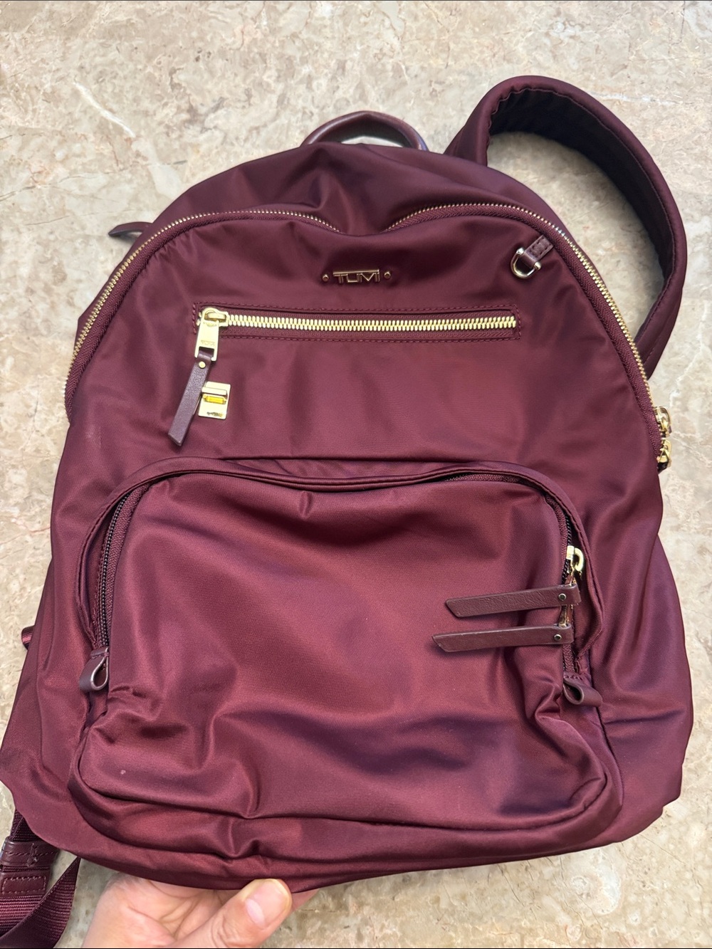 Tumi Women's Wine Red Backpack with Gold Hardware. Burgundy